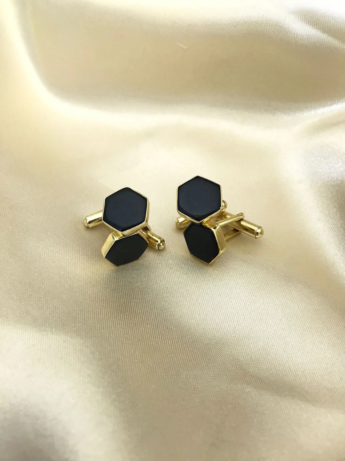 Black Onyx cufflinks by VARNIKA ARORA, elegant men's jewelry featuring polished black onyx stones and silver-tone settings.
