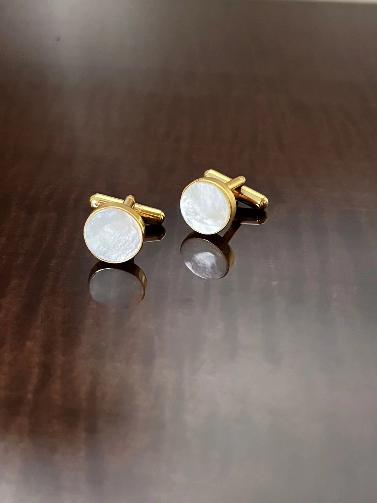 VARNIKA ARORA MOP cufflinks made of jewelry with a polished finish and intricate design, perfect for formal attire.