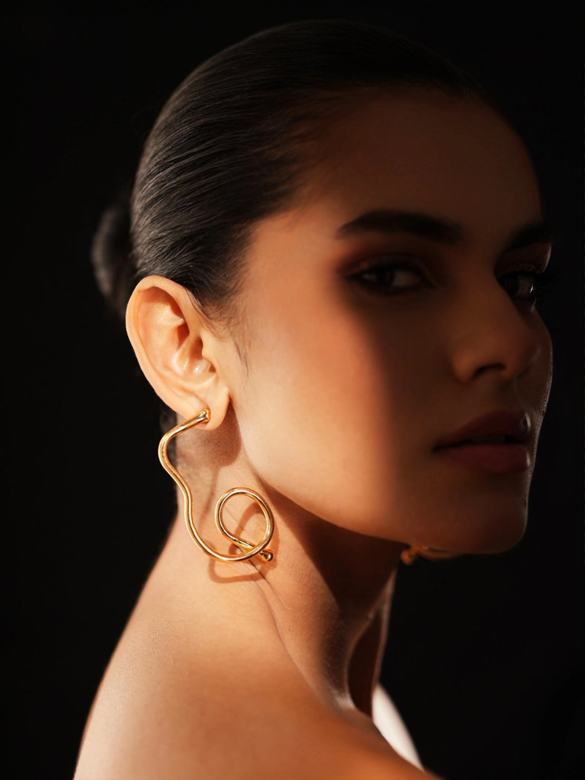 Varnika Arora Big Drift Hoop earrings featuring large gold hoops with intricate textured design and polished finish. Main image