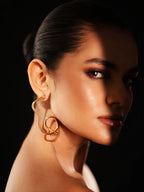 Varnika Arora Big Drift Hoop earrings featuring large, bold gold hoops with intricate detailing and a polished finish.