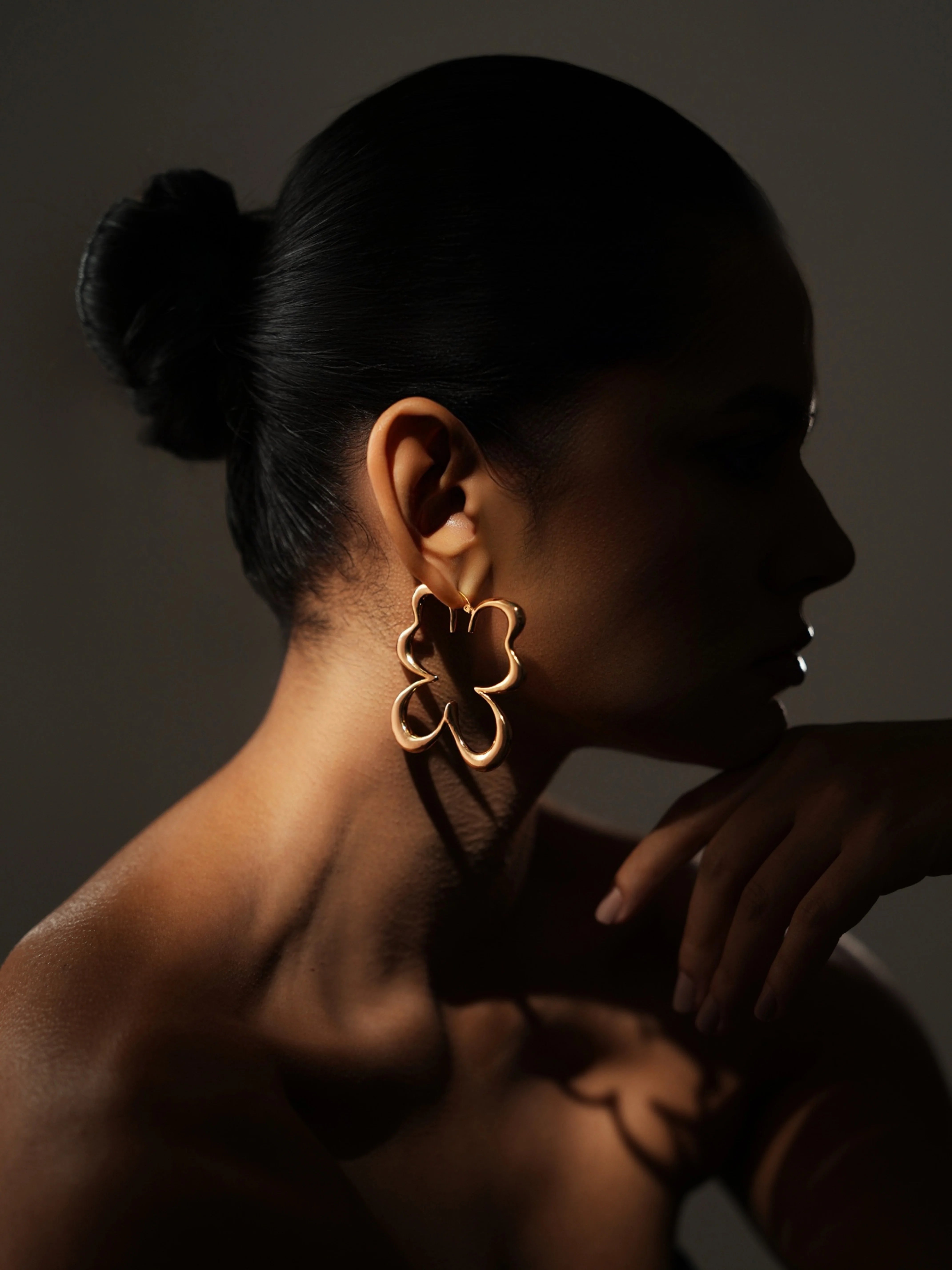 Varnika Arora Gilded Flutter Hoops featuring delicate gold-toned metal with a fluttering design, perfect for elegant jewelry styling. Main image