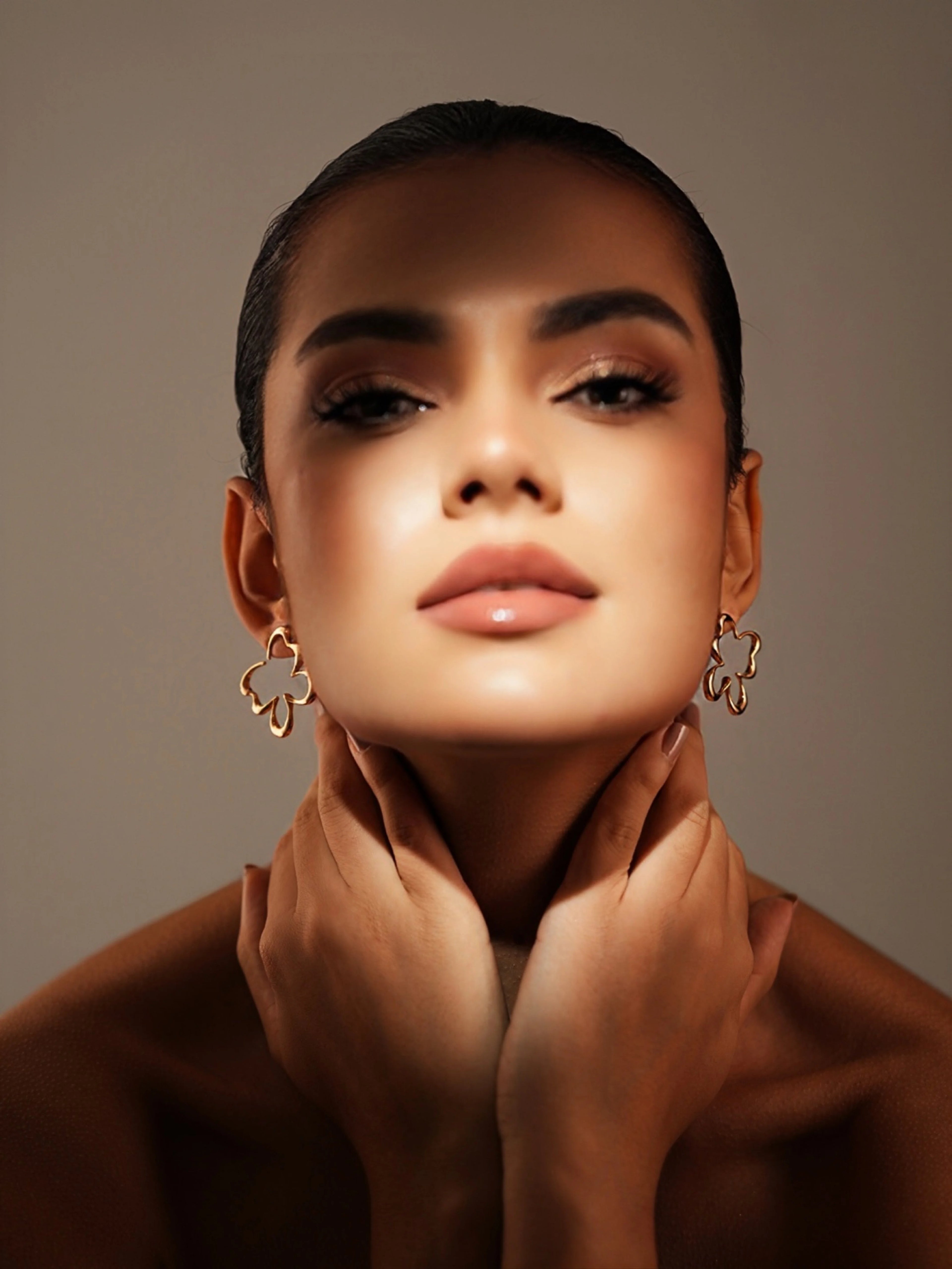Varnika Arora Flutter studs featuring elegant gold-toned designs with intricate detailing and a polished finish.