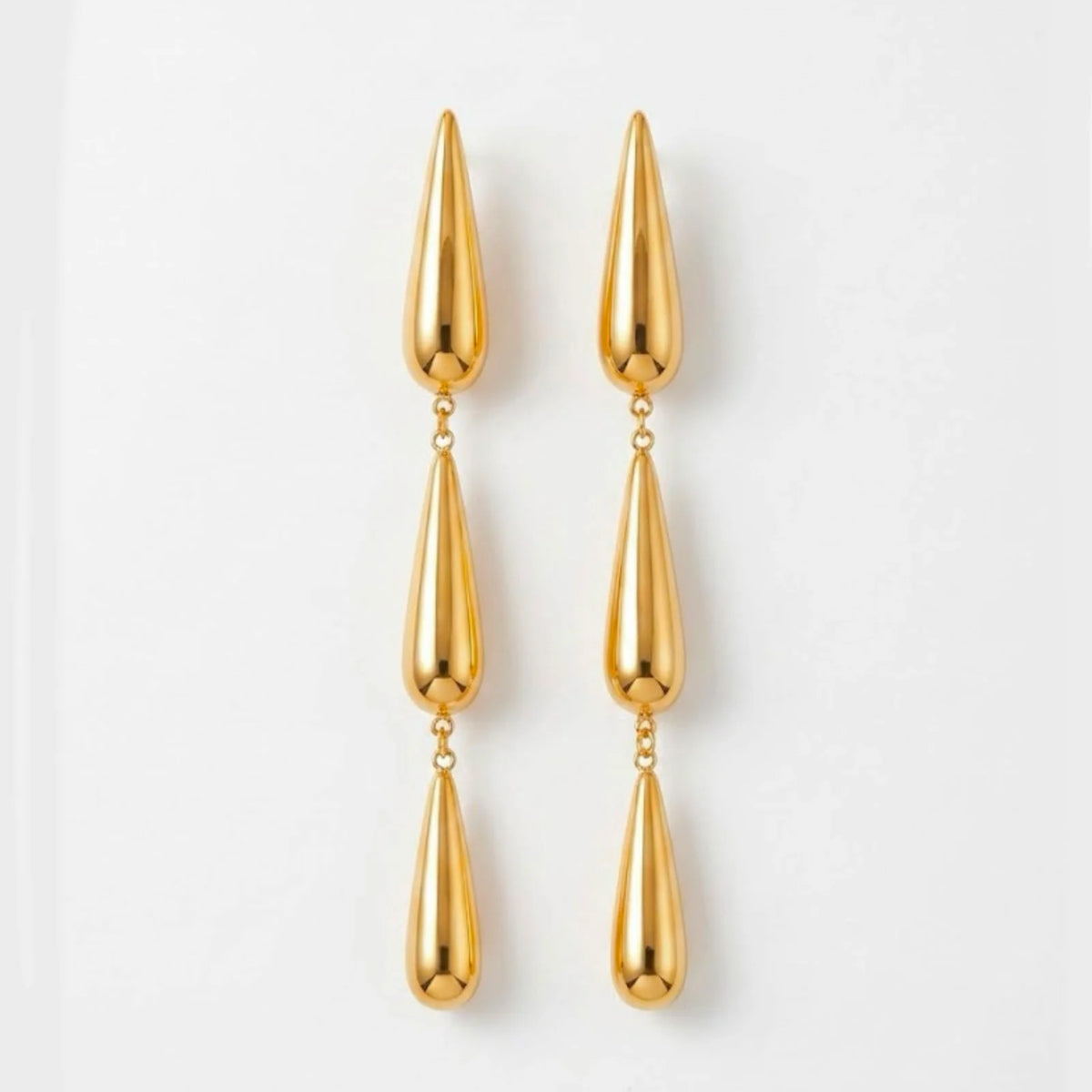 Varnika Arora Dewdrift Tier Drop earrings featuring layered gold-toned metal drops with intricate design details. Main image