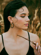 Small trio black enamel gold hoops by Varnika Arora, featuring three pairs of sleek, stylish gold hoop earrings with black enamel accents.