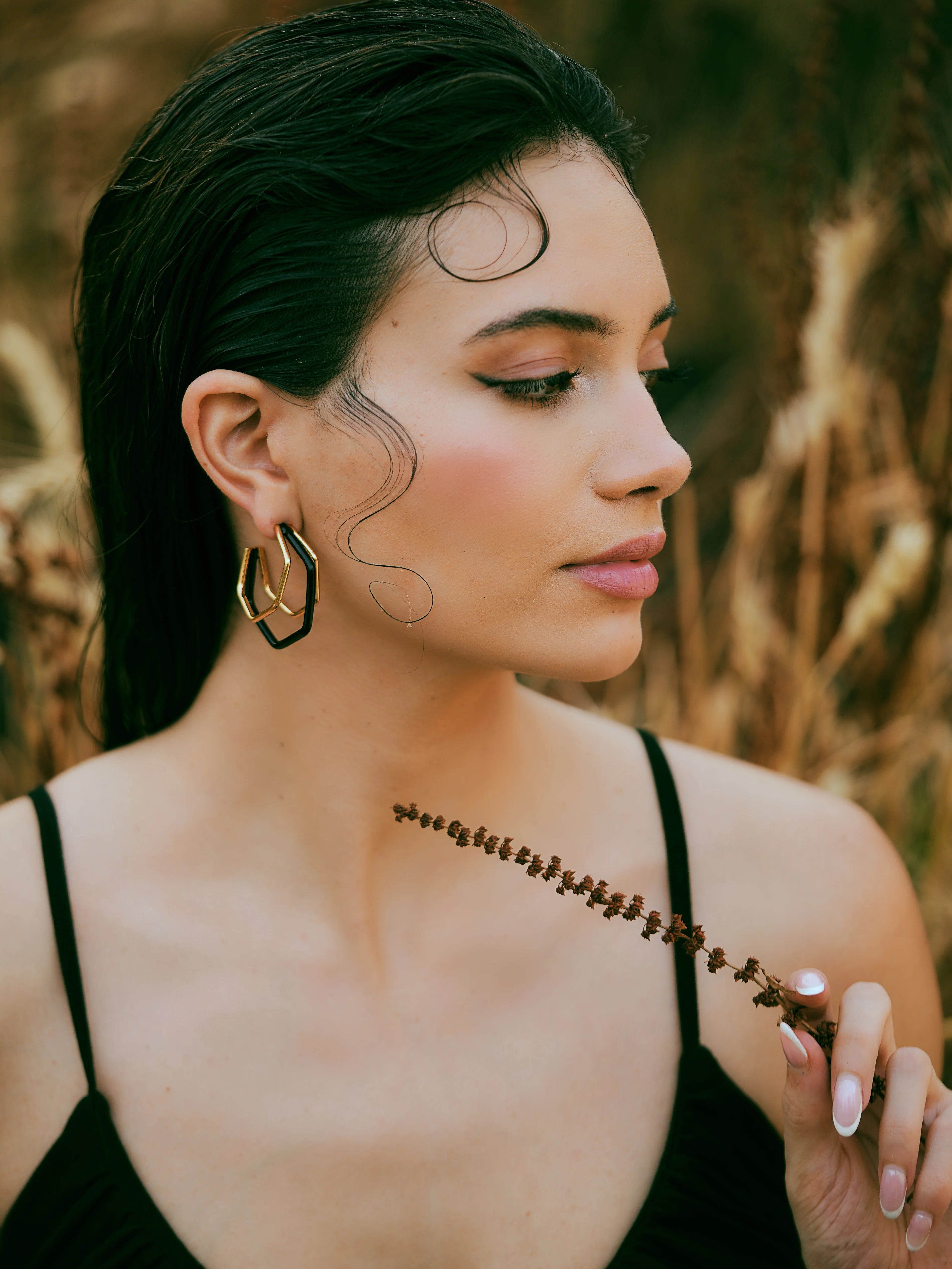 Small trio black enamel gold hoops by Varnika Arora, featuring three pairs of sleek, stylish gold hoop earrings with black enamel accents.