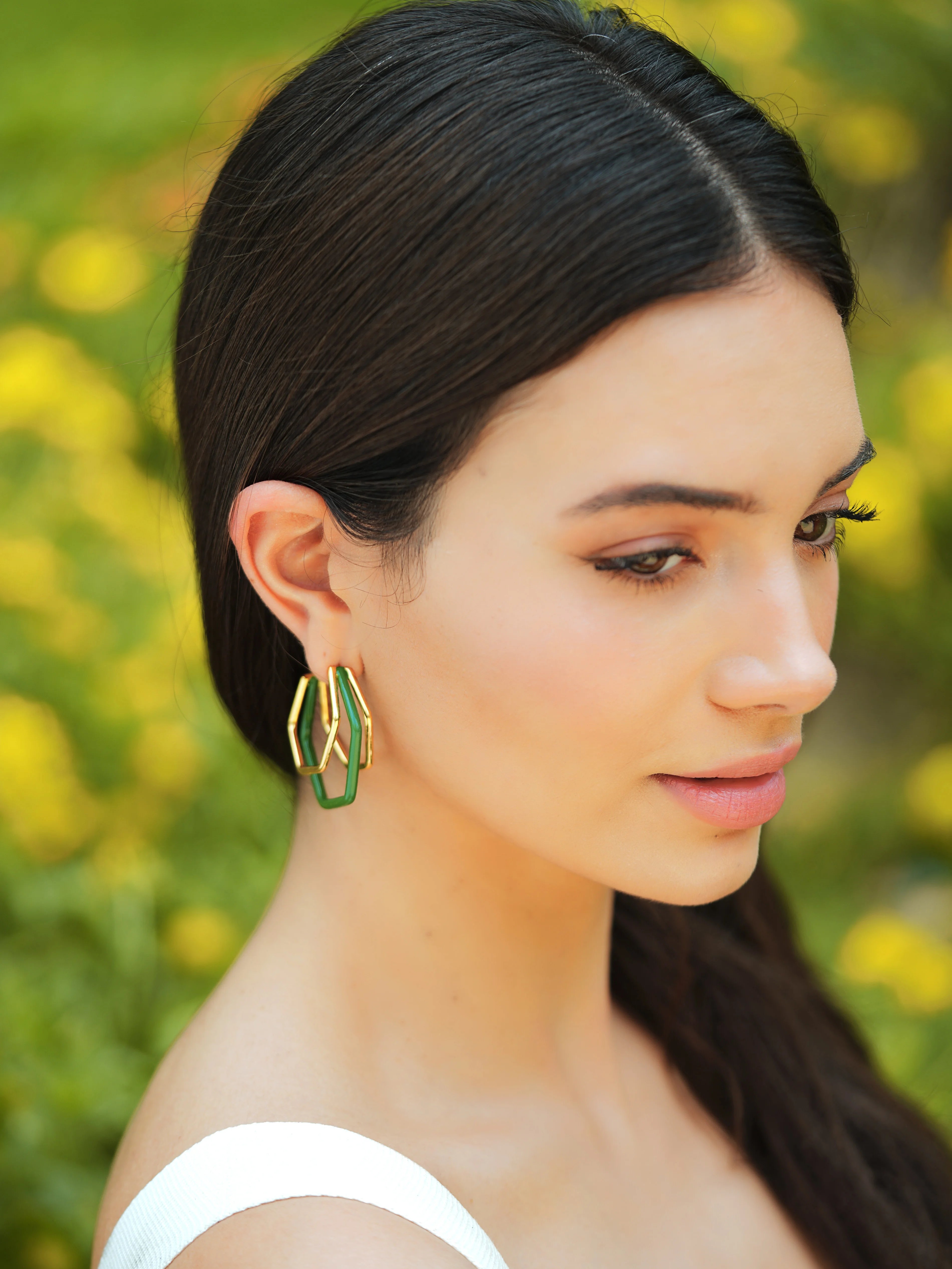 Small green enamel gold hoops by Varnika Arora, showcasing delicate hoop earrings with vibrant green enamel and gold finish.