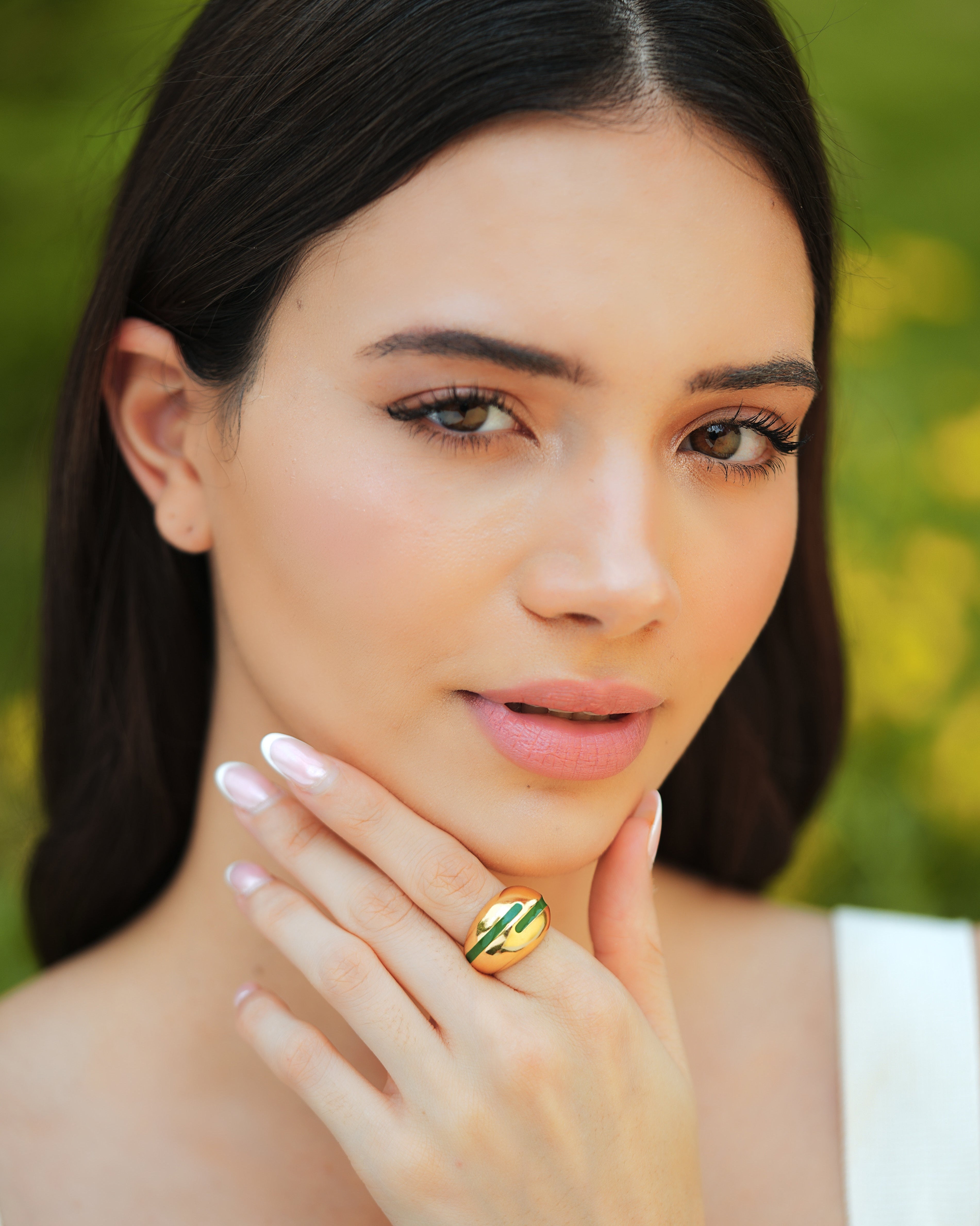 Varnika Arora Verdora green enamel gold ring shown on a person's finger with intricate design details. Main image