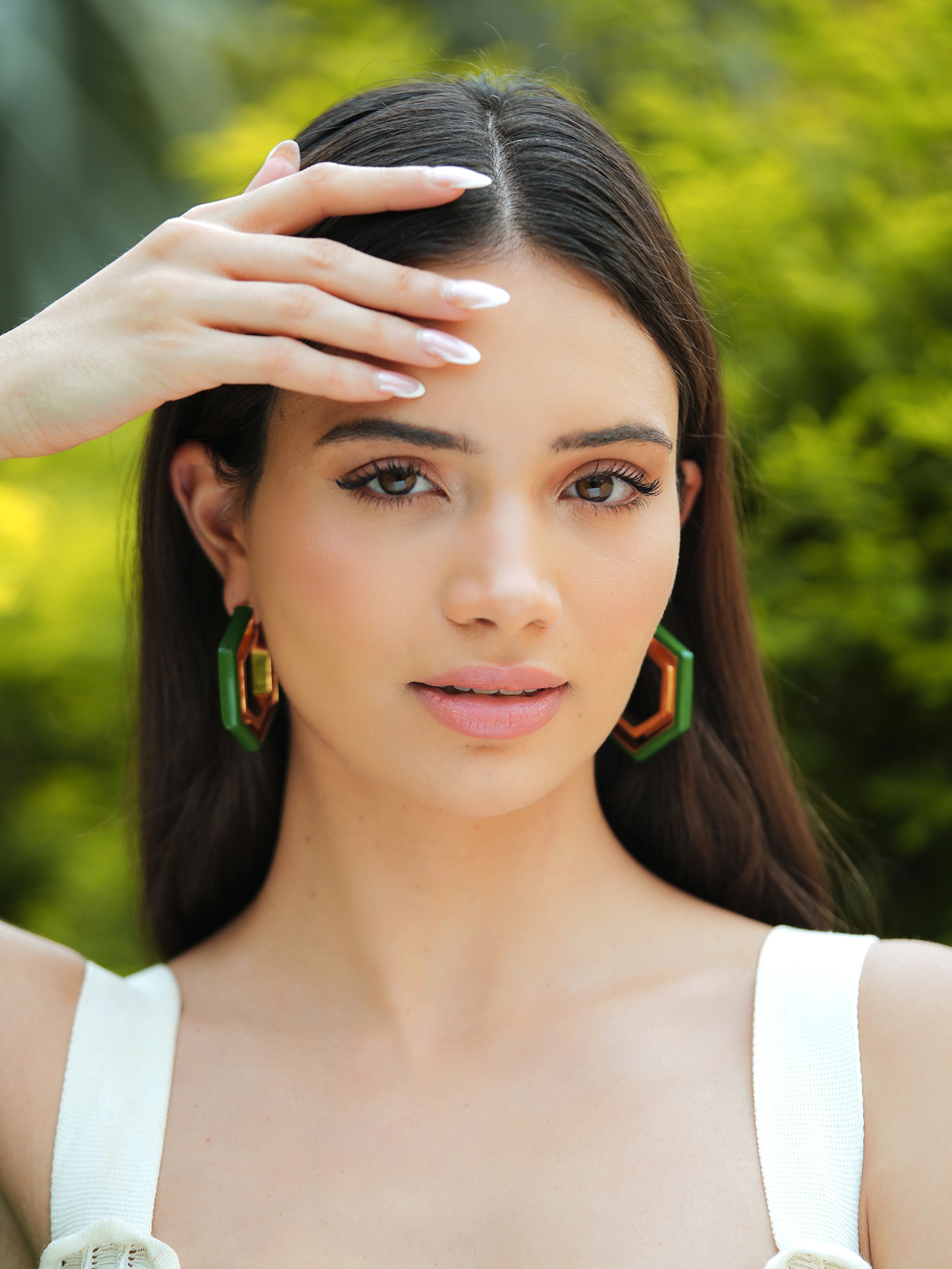 Varnika Arora Devine Green Enamel Gold Hoop Earrings with intricate design and shiny finish, close-up view of the jewelry.