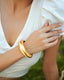 Varnika Arora white enamel gold bangle with intricate design, showcasing elegant jewelry craftsmanship.