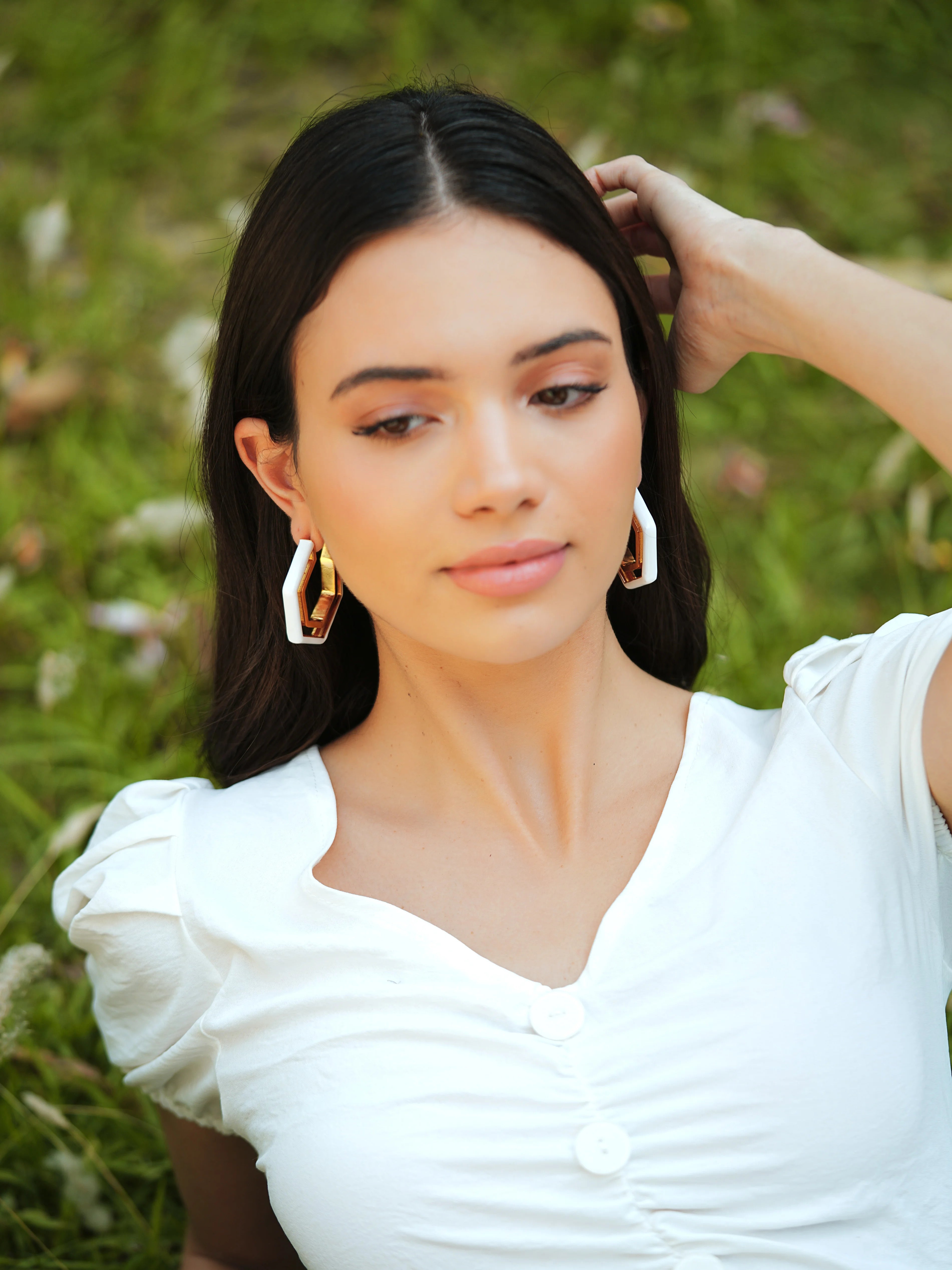 Varnika Arora Devine White Enamel Gold Hoop Earrings displayed with intricate white enamel and gold finish on classic hoop design.