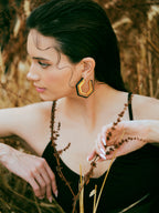 Varnika Arora Devine black enamel gold hoop earrings with sleek, polished design and classic hoop style.