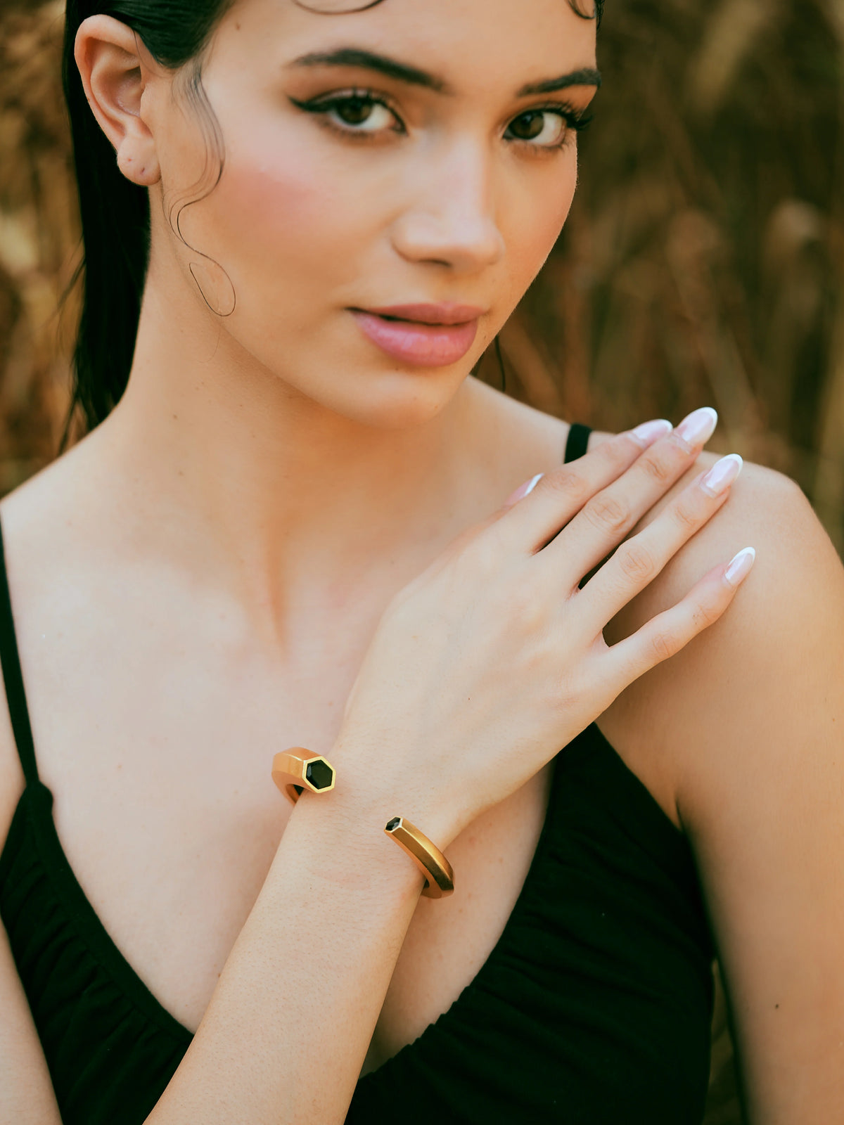 Varnika Arora Hexa Black Enamel Gold Bangle cuff with geometric design, showcasing elegant black and gold jewelry details.