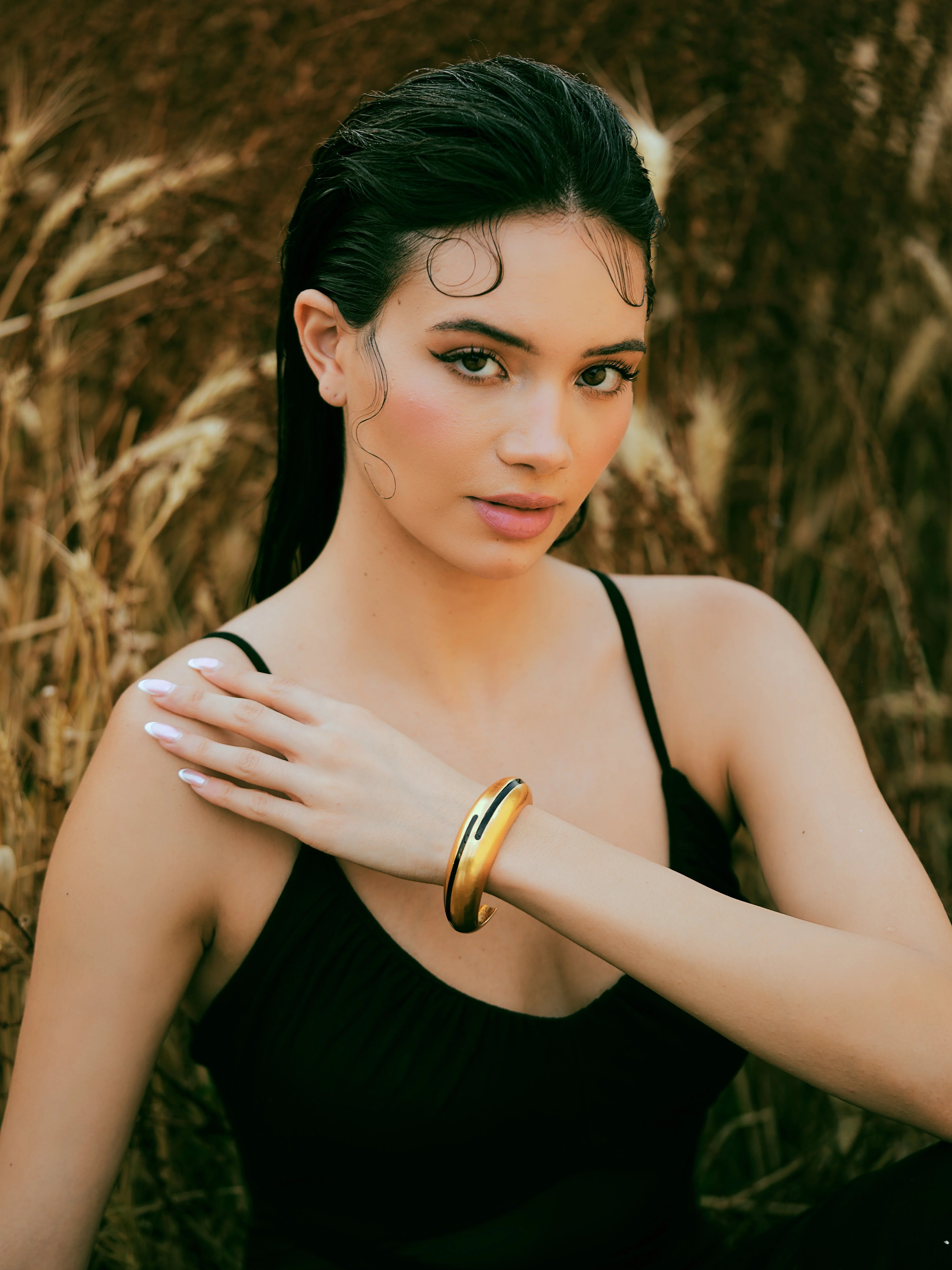 Varnika Arora black enamel gold bangle with elegant circular design, showcasing a sleek and polished jewelry piece. Main image