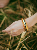 Black enamel and gold bangle from Varnika Arora's Circlet collection, featuring a sleek, elegant design perfect for stylish accessories.