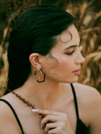 Small trio black enamel gold hoops by Varnika Arora, featuring three stylish hoop earrings with black enamel and gold finish.