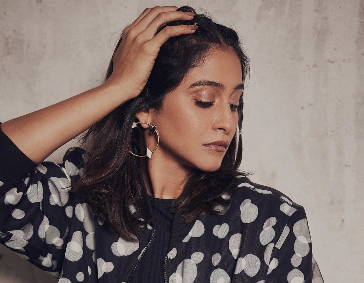 Regina Cassandra wearing Varnika Arora teeny earrings, close-up of her face and earrings at a photoshoot on September 5, 2022. Main image