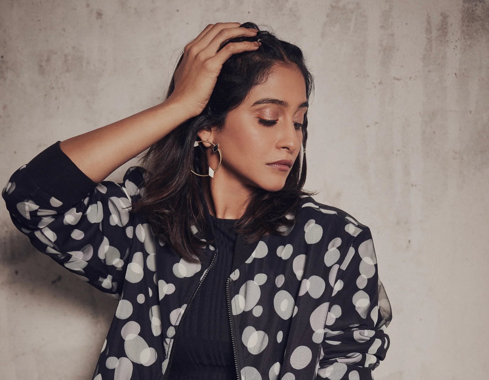 Regina Cassandra wearing Varnika Arora teeny earrings, close-up of her face and earrings at a photoshoot on September 5, 2022. Main image