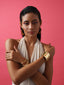Varnika Arora La Fiore Glory Bangle jewelry with intricate gold design and floral accents on a white background.