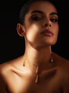 Dewdrop necklace by Varnika Arora featuring a delicate silver chain with a shimmering teardrop pendant.