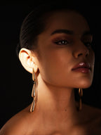 Varnika Arora Dewdrift Tier Drop jewelry featuring layered, delicate tiered drop designs on a white background.