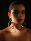Varnika Arora Pulse Hoop in gold with intricate designs, close-up view showing detailed craftsmanship and shiny finish.