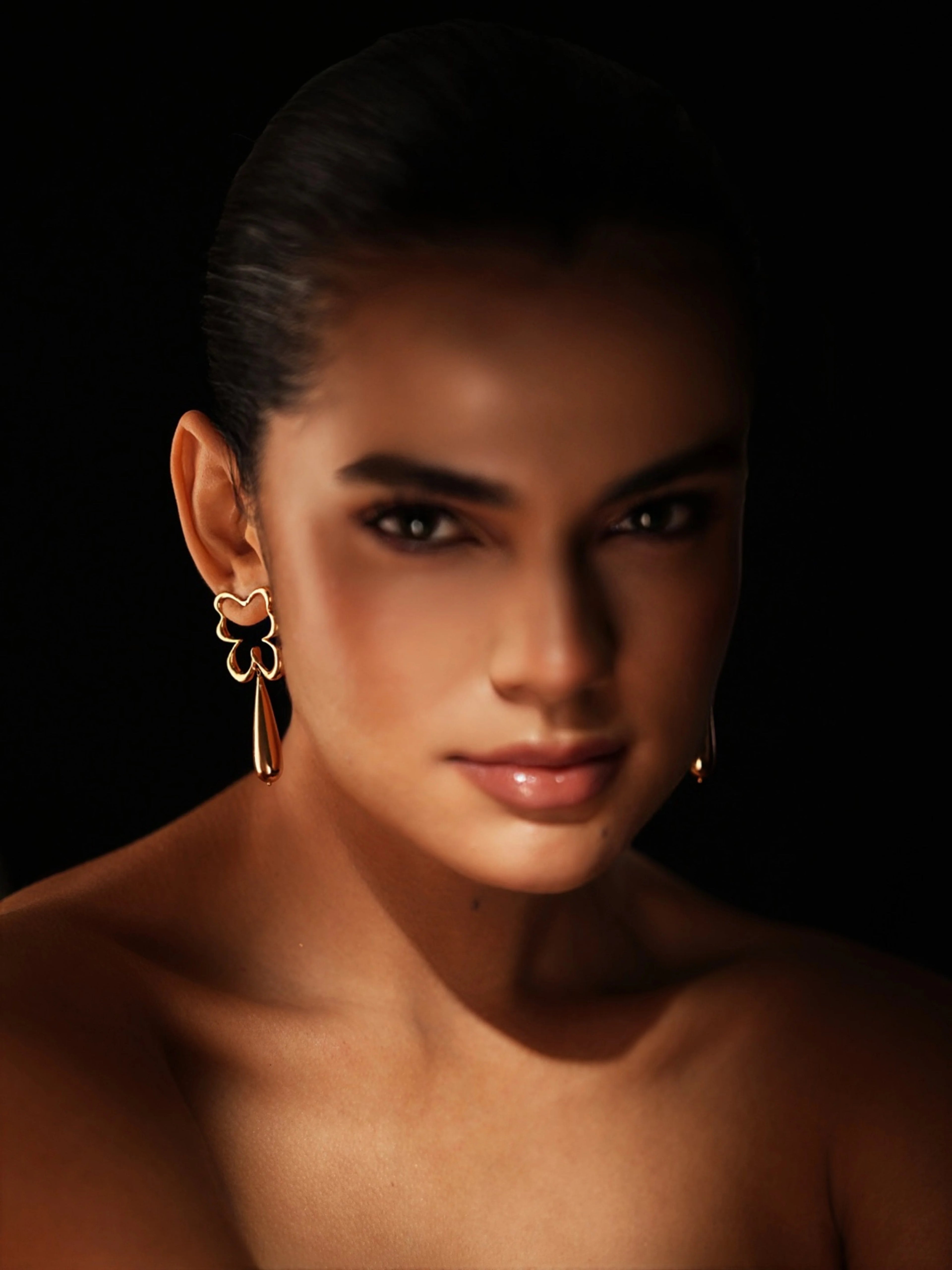 Varnika Arora Bloom Tear Earrings featuring elegant floral-inspired gold-toned design with hanging teardrop shapes.