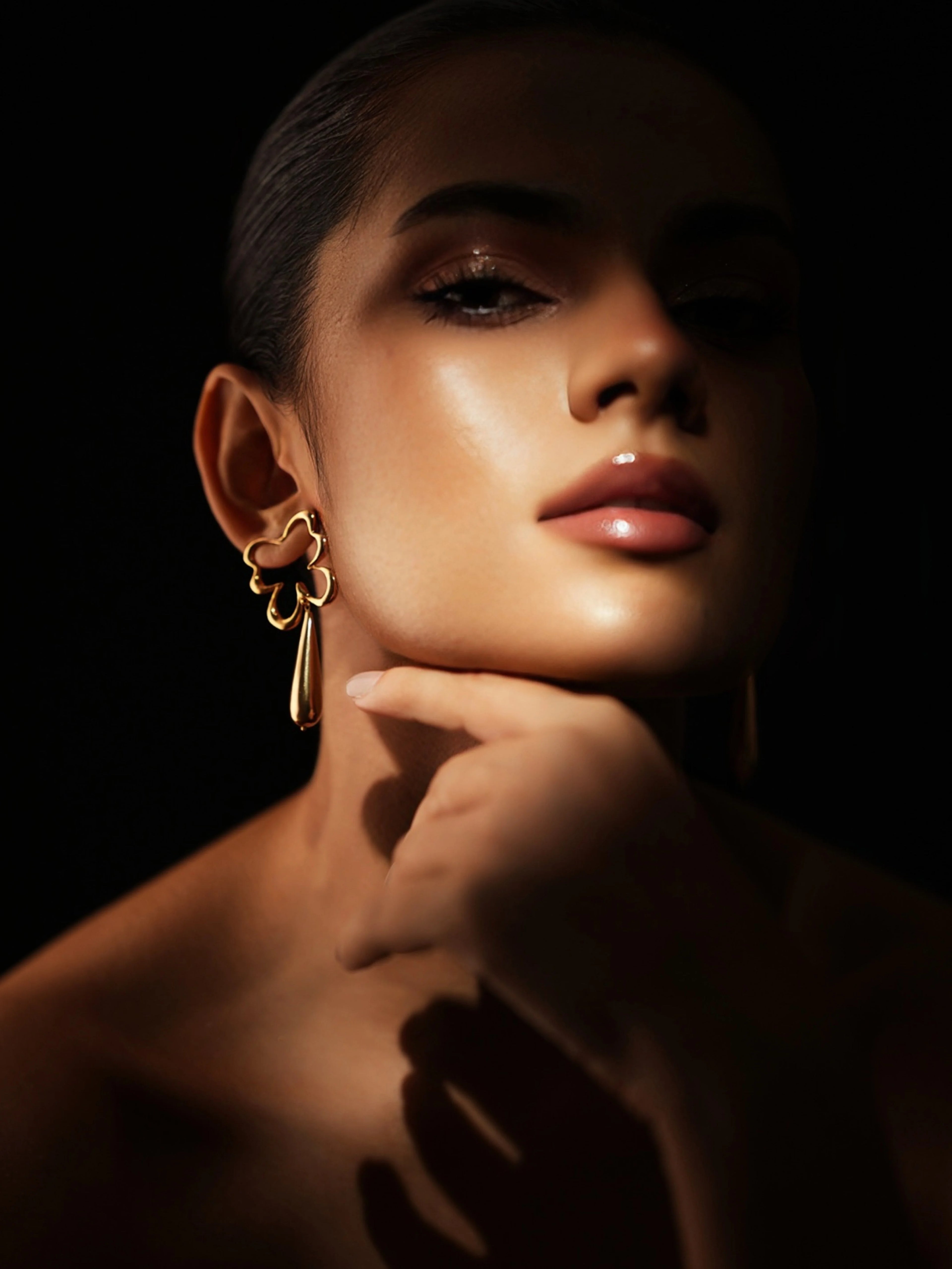 Varnika Arora Bloom Tear Earrings with floral-inspired design in gold-tone metal, displayed on a white background.
