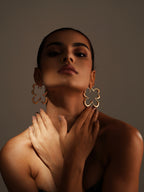 Varnika Arora Gilded Flutter Hoops featuring elegant gold-toned, fluttering hoop earrings with intricate design details.