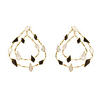 Varnika Arora Sporadic earrings featuring delicate gold hoops with intricate detailing on a white background.