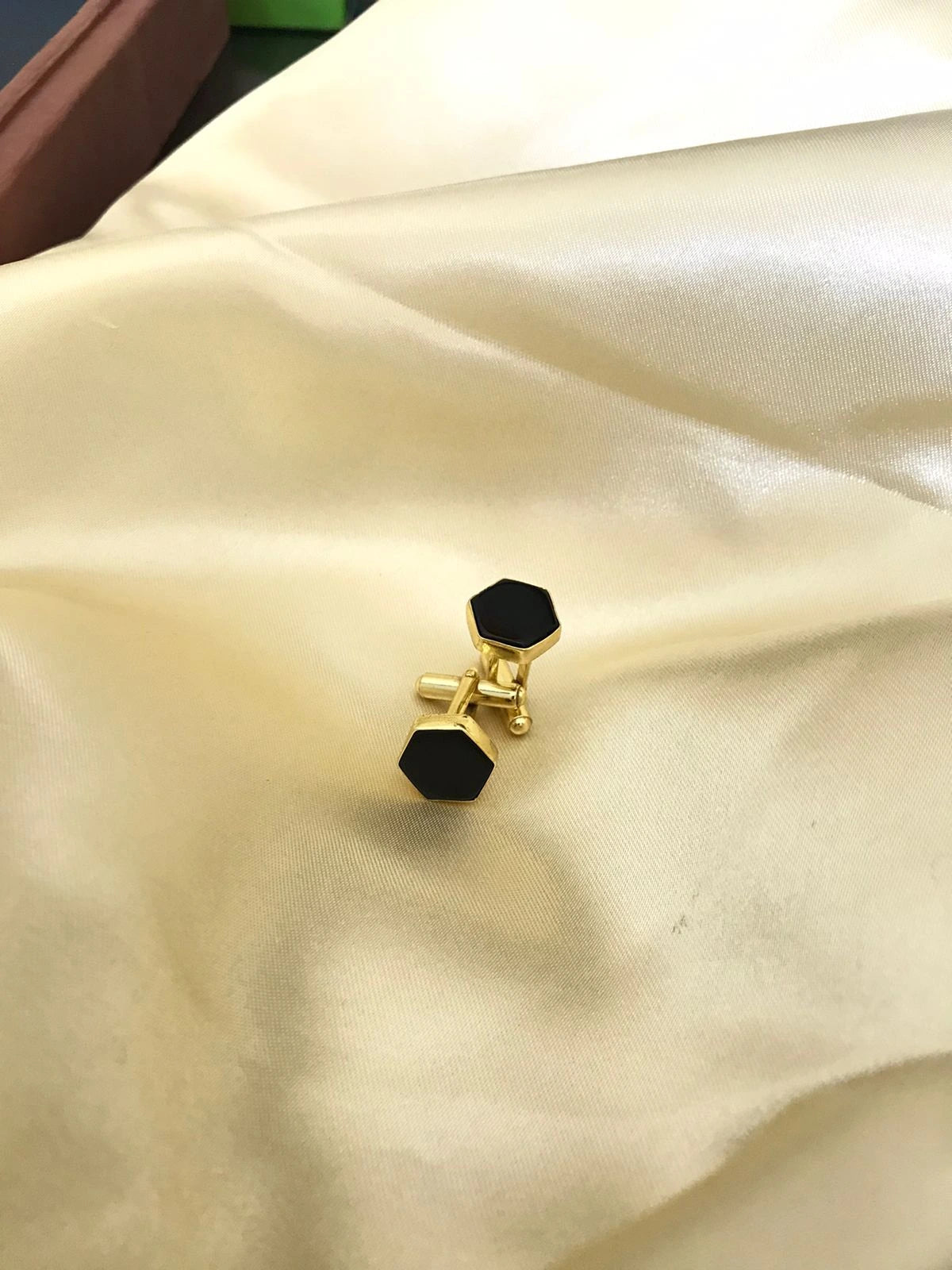 Black Onyx cufflinks by VARNIKA ARORA, elegant jewelry with polished black onyx stones and silver-tone setting.