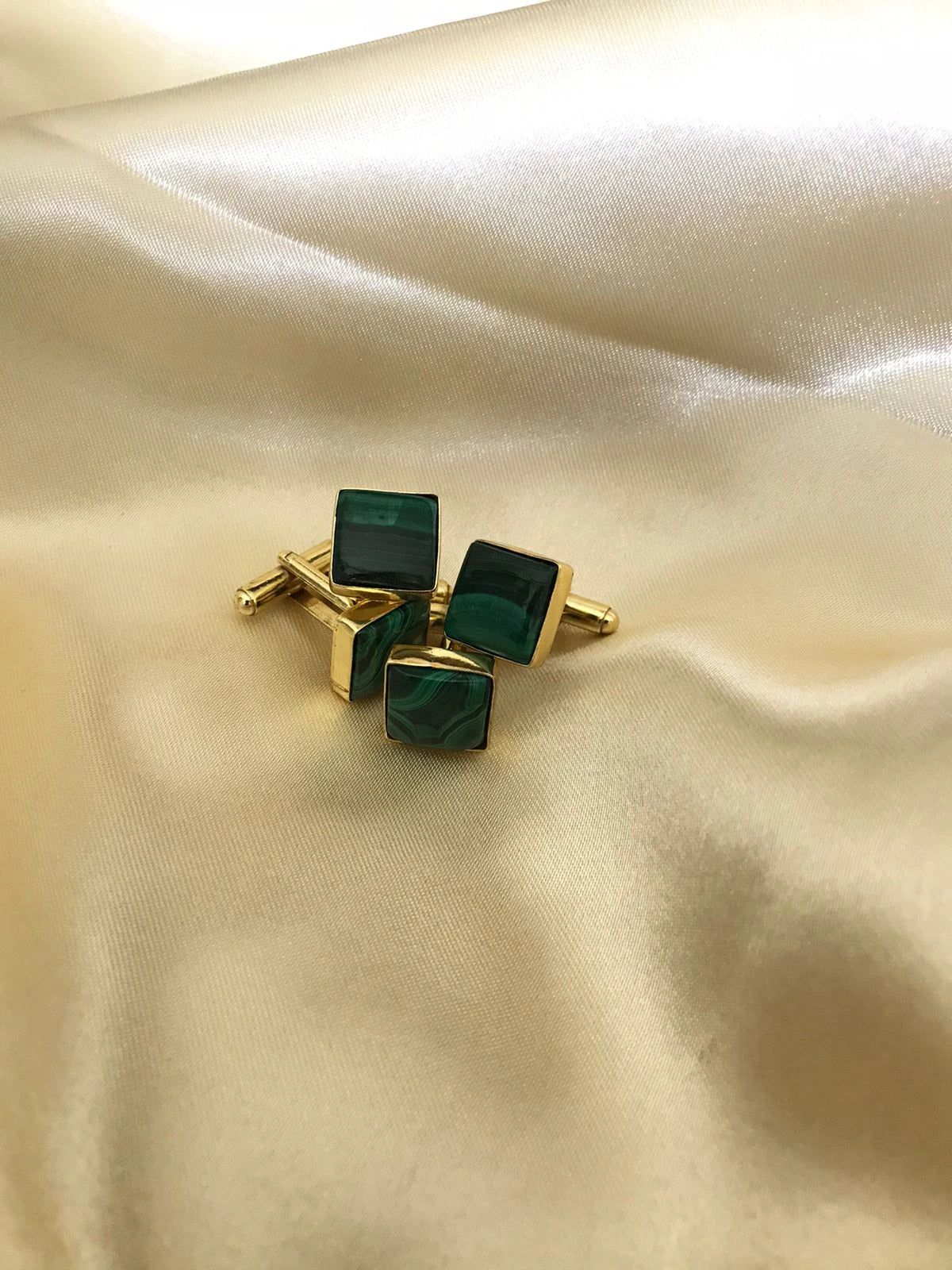 VARNIKA ARORA malachite cufflinks showcasing polished green gemstone jewelry with silver-tone metal accents.