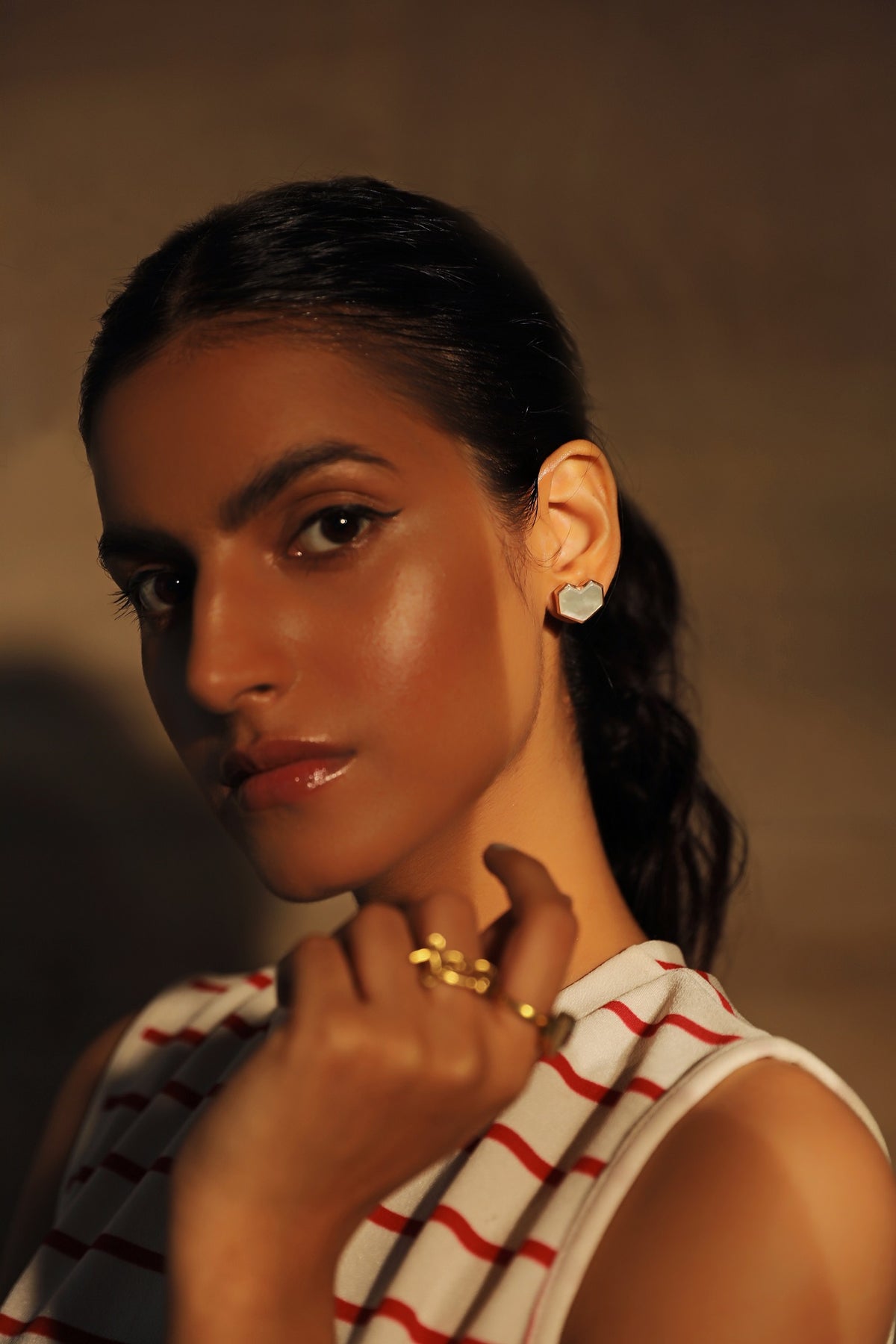 Varnika Arora Regina Cassandra hearty stud earrings in gold with intricate detailing, displayed on a neutral background. Main image